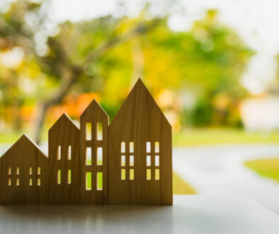 Wooden house model on wood background, a symbol for construction , ecology, loan, mortgage, property or home.