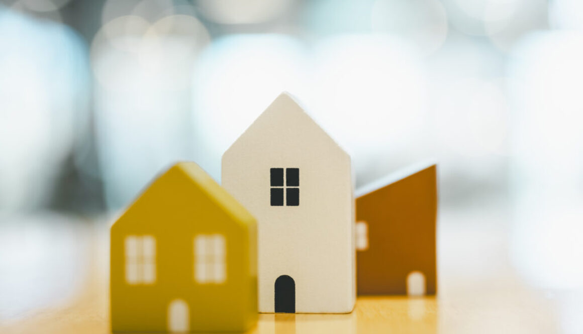 Wooden house model on wood background, a symbol for construction , ecology, loan, mortgage, property or home.