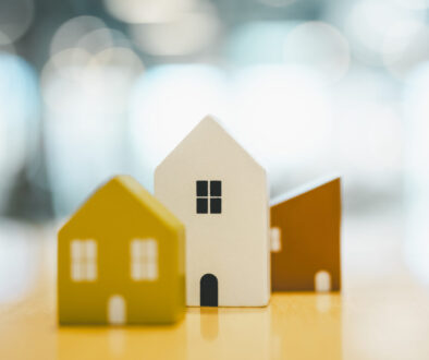 Wooden house model on wood background, a symbol for construction , ecology, loan, mortgage, property or home.