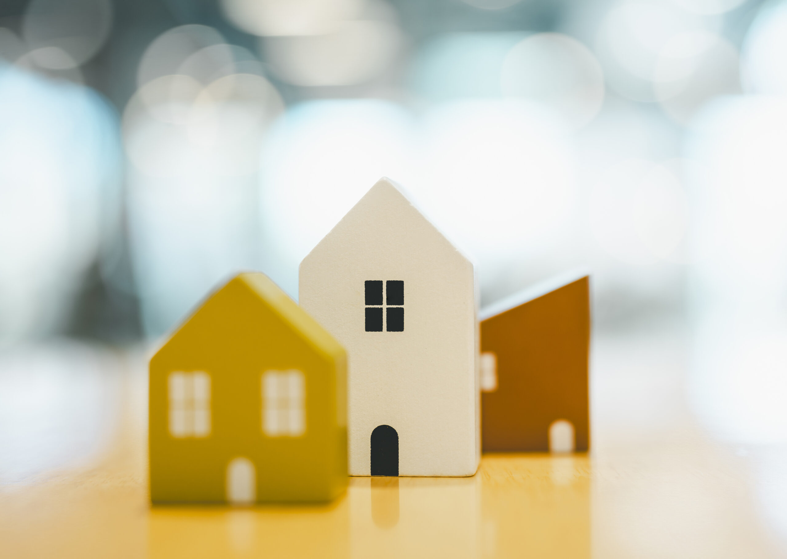 Wooden house model on wood background, a symbol for construction , ecology, loan, mortgage, property or home.