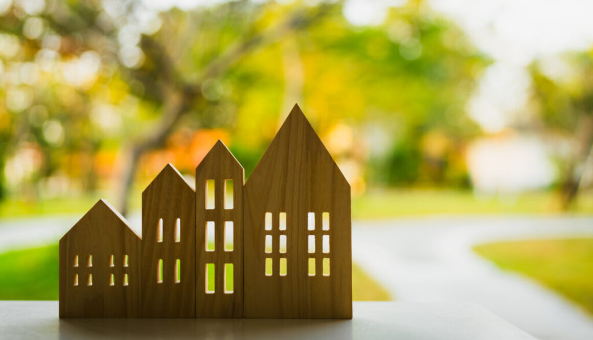 Wooden house model on wood background, a symbol for construction , ecology, loan, mortgage, property or home.