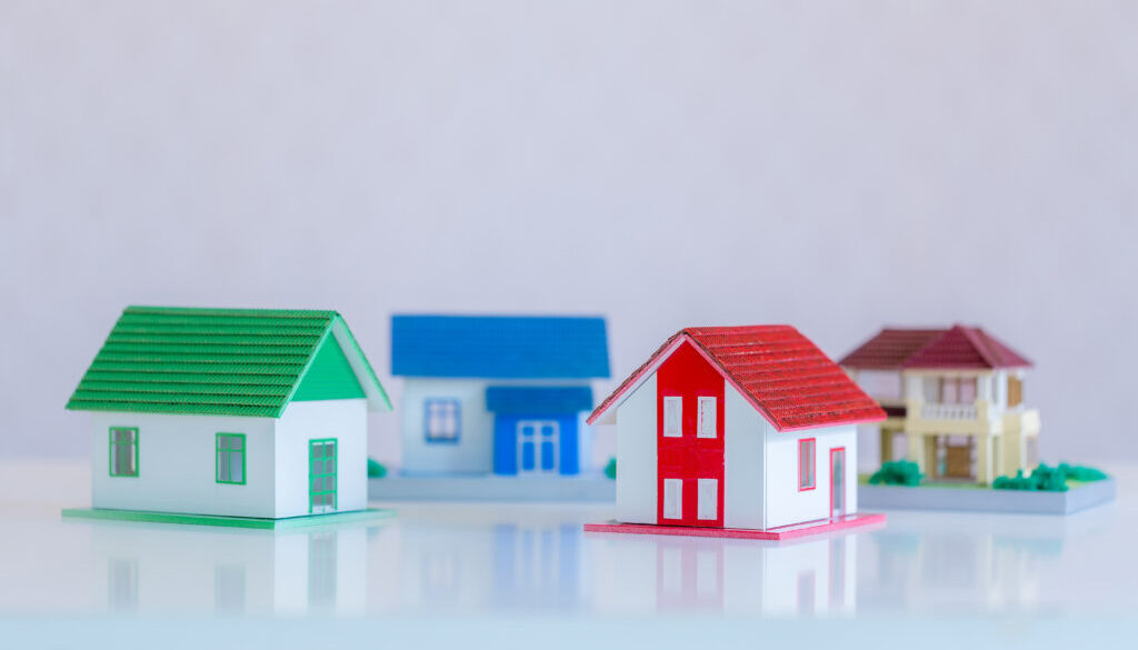 Model of house painted white under the tiled roof on the white b