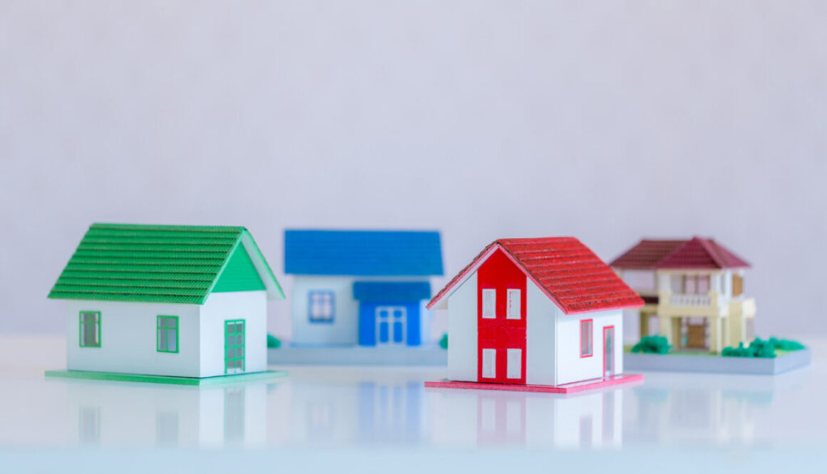 Model of house painted white under the tiled roof on the white b
