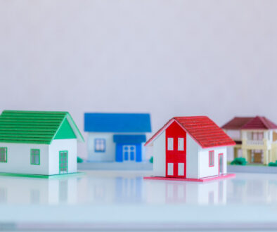 Model of house painted white under the tiled roof on the white b